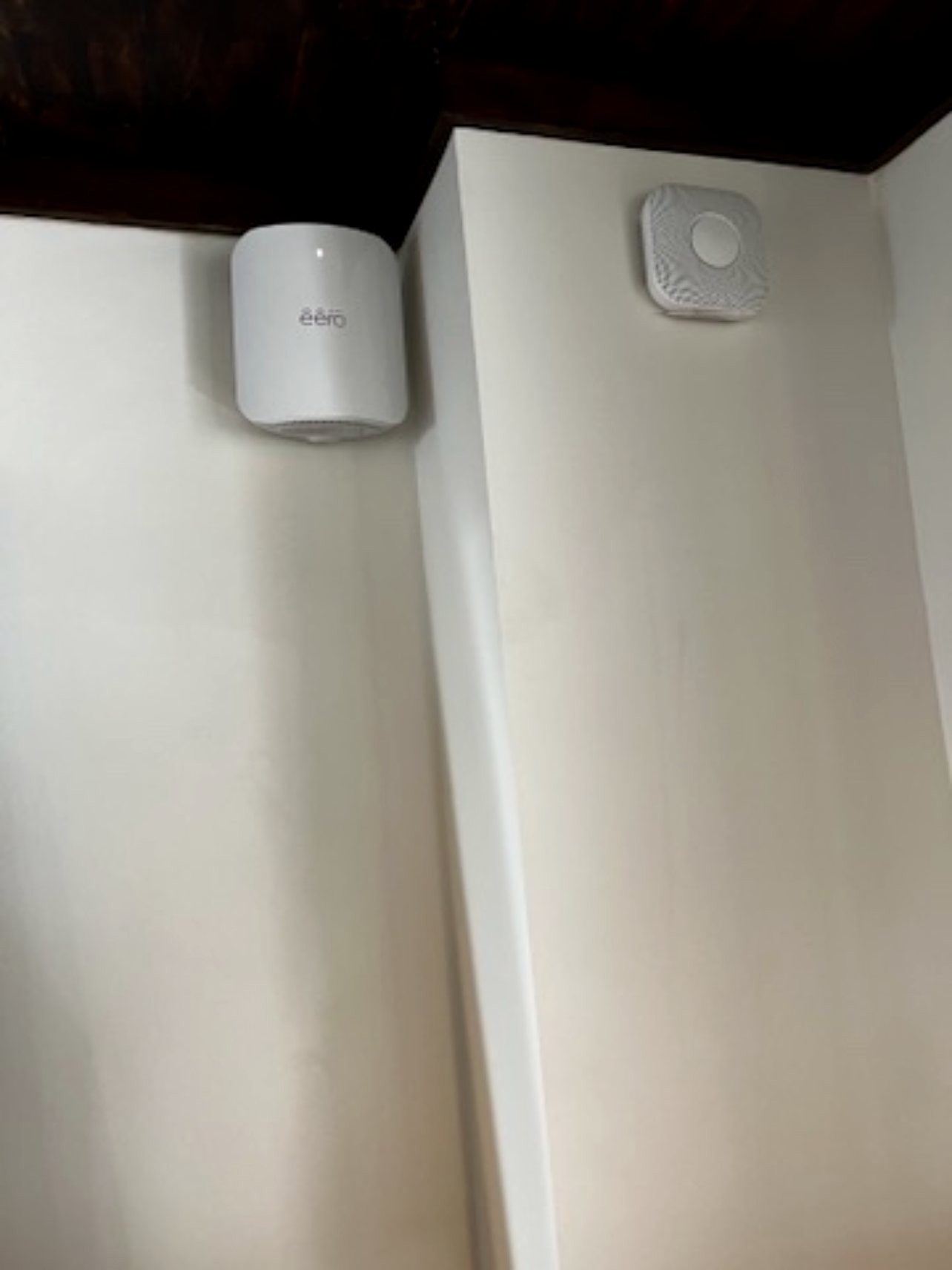 Aqara smart-home hub and corner motion sensor mounted to a wall