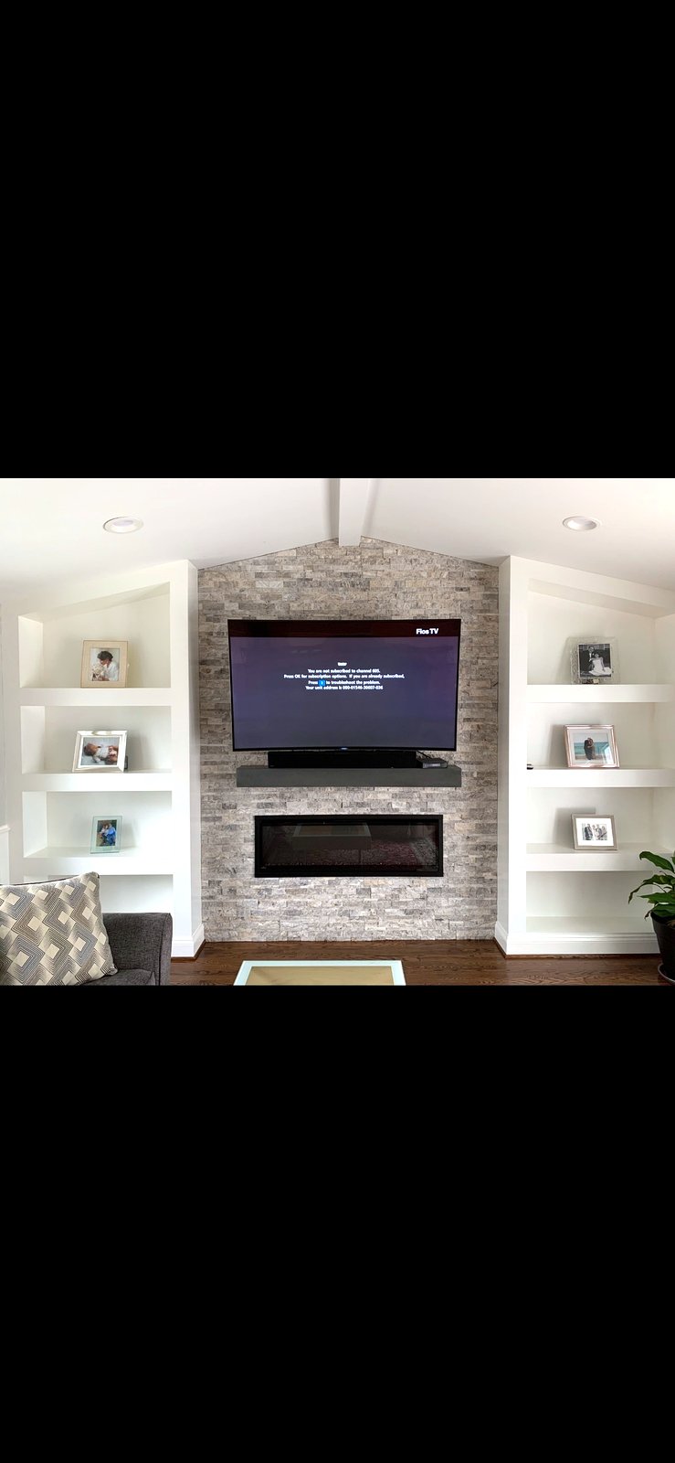 TV with linear fireplace and built-in shelves