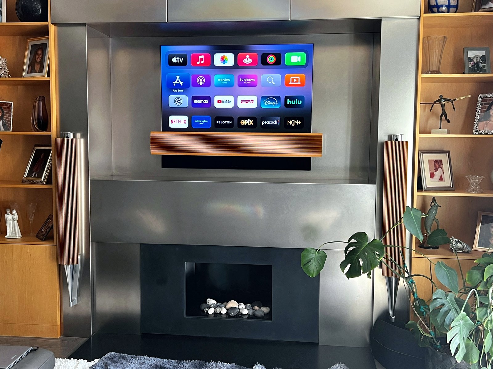 TV on steel fireplace with B&O speakers